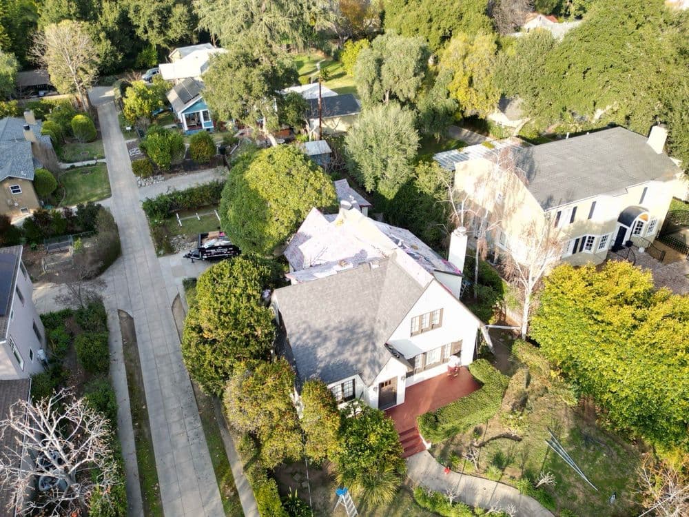Aerial view of a residential neighborhood featuring houses and greenery.